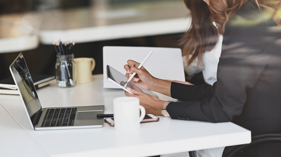 Cropped shot businesswoman meeting they tablet on modern office.